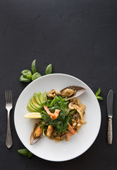 Warm salad with grilled seafood flat lay