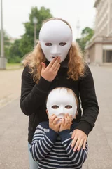 Fotobehang Girl and boy with a white mask with surprise gesture © Aitor Diago