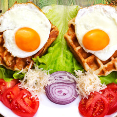 Traditional  breakfast. Fried eggs and tomatoes on a white plate. Sprinkled with grated cheese.