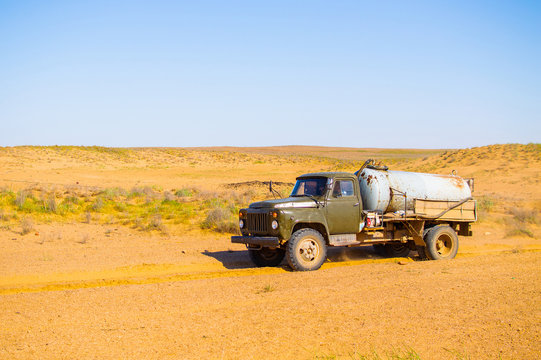 Truck With Water Tank In Sand Desert