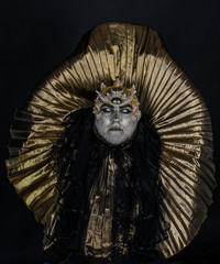 Man with third eye, thorns or warts. Demon with golden collar on black background. Alien, demon,...