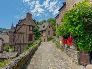 Fototapeta na wymiar Conques, Midi Pyrenees, France - July 31, 2017: Typical narrow stone streets in the village of Conques