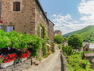 Conques, Midi Pyrenees, France - July 31, 2017: Typical narrow stone streets in the village of...