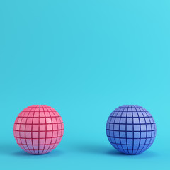 Abstract segmented spheres on bright blue background in pastel colors