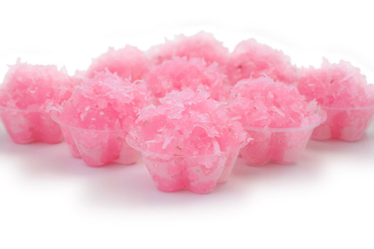 Pandan pink flavored sweet translucent gelatinous rice on white floor.
