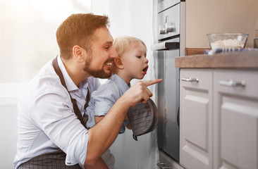 father with   child   son prepares meal, bakes cookies.