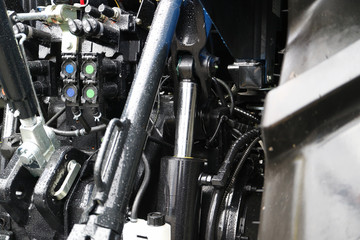 Trailing device of a modern tractor. Power cylinders.