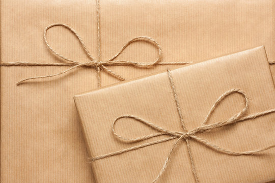 Close up of two gift boxes wrapped in brown recycled paper