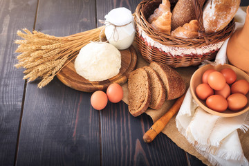 Fototapeta na wymiar Breakfast from farm products: eggs, milk, bread on a wooden table.