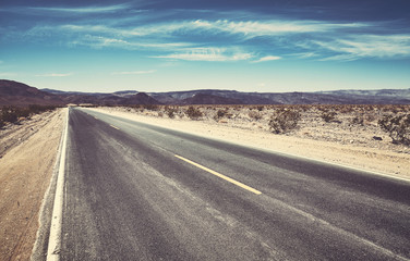 Fototapeta premium An empty desert road, color toning applied.