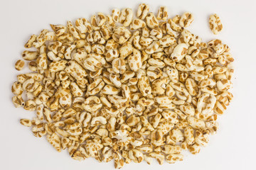 heap of puffed spelt cereal with honey