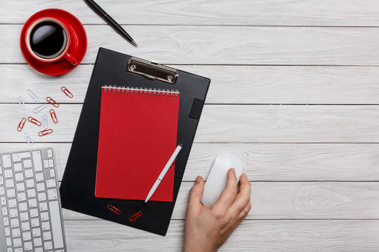 white board desk folder red shuttles cup of coffee clock paper clips keyboard mouse working process at the computer