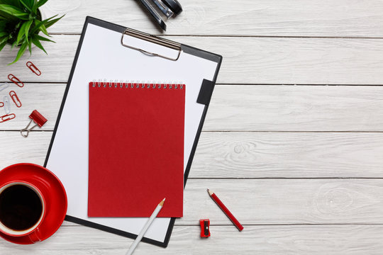 white table boards folder red notepad cup morning coffee clock paper clip office office