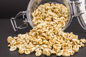 puffed spelt cereal with honey in a glass jar
