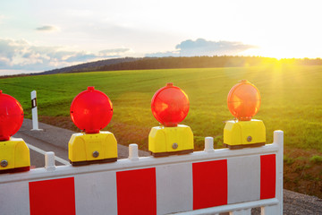 closeup of street warning lights at road on countryside