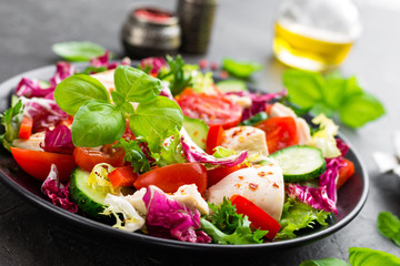 Salad with chicken meat. Fresh vegetable salad with chicken breast. Meat salad with chicken fillet and fresh vegetables on plate