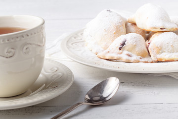 Homemade savory hand pies with cup of tea, breakfast concept