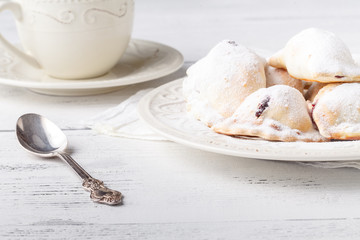 Homemade savory hand pies with cup of tea, breakfast concept