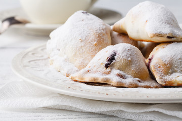 Homemade savory hand pies with cup of tea, breakfast concept