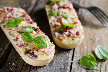 Pizza on baguette with basil