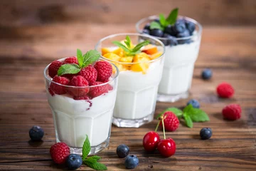 Fotobehang Fresh fruit yogurt with fresh berries and peaches © pilipphoto