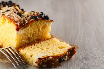 cake with almonds and blueberries on wooden table. Closeup. Copyspace