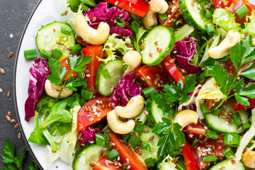 Vegetable salad. Fresh salad with vegetables and nuts. Vegetable salad on plate. Healthy vegetarian food