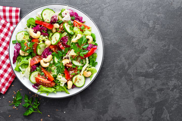 Vegetable salad. Fresh salad with vegetables and nuts. Vegetable salad on plate. Healthy vegetarian food