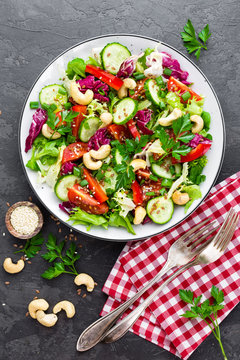 Vegetable salad. Fresh salad with vegetables and nuts. Vegetable salad on plate. Healthy vegetarian food