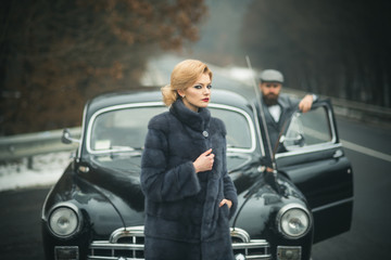 nostalgia concept. nostalgia and retro car at bearded man and woman in coat.