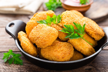 Nuggets. Chicken nuggets with ketchup on wooden table. Fast food