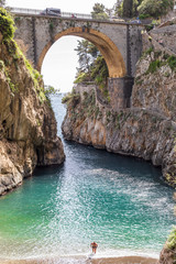 Fiordo di Furore beach. Furore Fjord, Amalfi Coast, Positano, Naples, Italy. - Men walking out the...