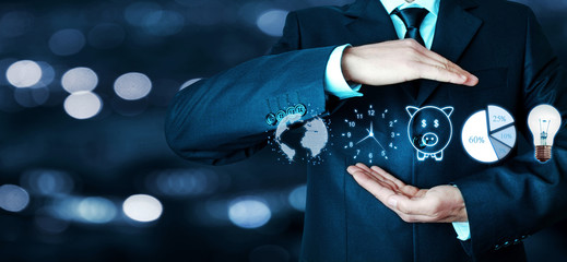 Man holding globe, clock, piggy bank, pie graph and light bulb. Business concept