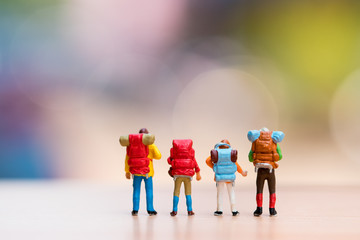 Miniature people, the backpackers standing action using as travel and exploring concept