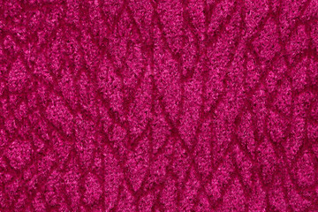 Saturated pink fabric texture with ornament.
