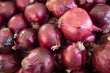 Red onions in plenty on display at local farmer's market,  Big fresh red onions background