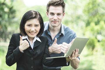 successful partners caucasian and asian girl work together with happiness and joyful