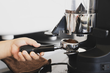 Close-up of espresso pouring from coffee machine. Professional coffee brewing, Barista Cafe making coffee preparation service concept, Vintage tone