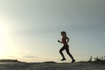 Fototapeta na wymiar Woman silhouette running in sunset image