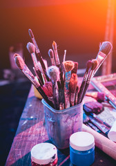 Artist's brushes in the bank. Creator's workplace