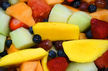 Close up on mixed fruit salad as food background