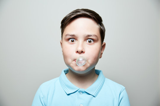 kid blowing bubble gum