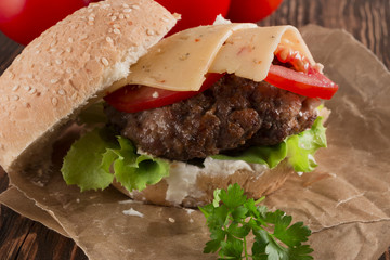 Delicious burgers with beef, tomato, cheese and lettuce