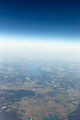 Obraz premium View from the airplane to the sky above the Alps mountains. Blue sky with clouds. Background.