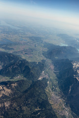 Obraz premium View from the airplane to the sky above the Alps mountains. Blue sky with clouds. Background.