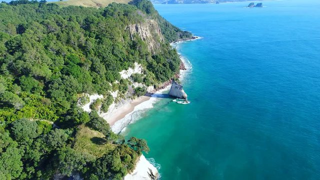 Aerial view of white cliffs and beaches of Cathedral Cove - South Pacific Ocean shore, Coromandel Peninsula, North Island, New Zealand from above, 4k UHD