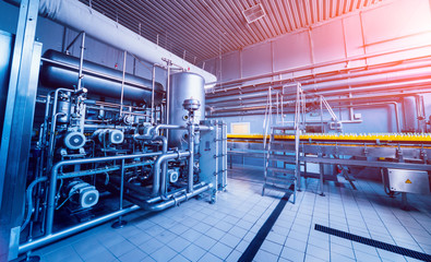 Modern interior of a brewery. Barrels and pipes. Factory interior.