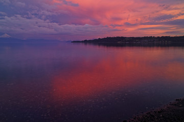 Frame of a time lapse - Sunset in Frutillar overlooking Lake Llanquihue and the Osorno and Calbuco volcanoes