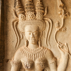 Fototapeta premium Detail of sculpted stone in Angkor Wat. Relief on the wall in temple. Cambodia