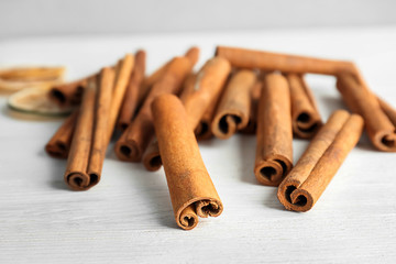 Aromatic cinnamon sticks on wooden background